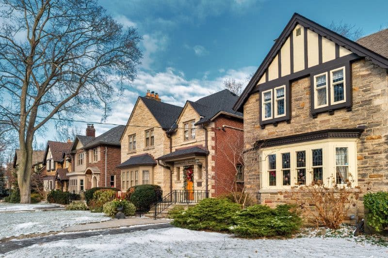 Homes along a snowy street in The Kingsway, Toronto.
