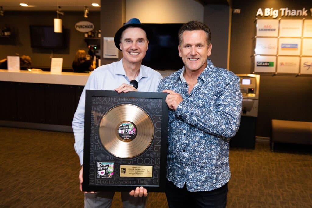 Dan Cooper receiving a gold record style award