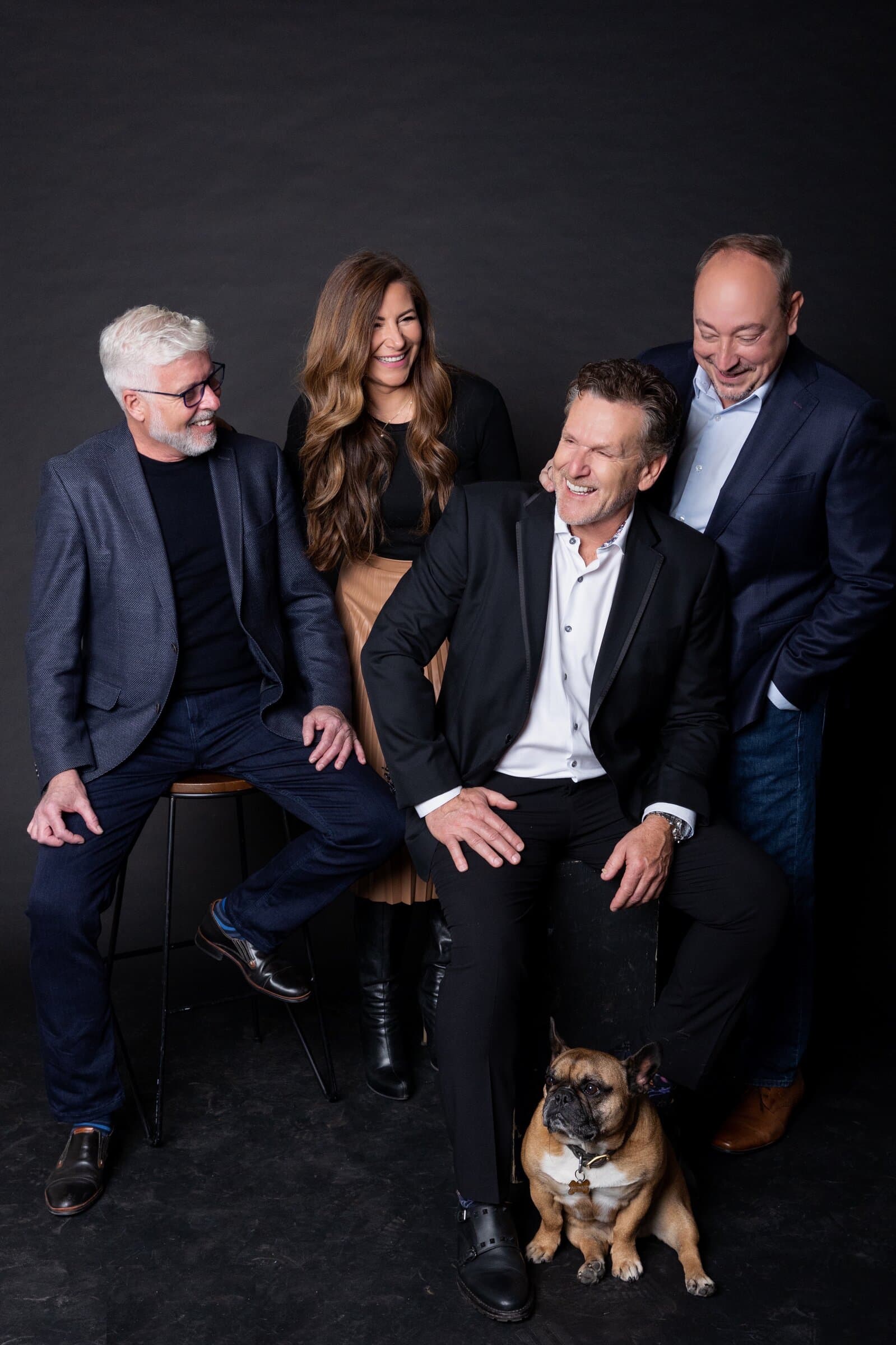 The Dan Cooper Group team in the studio with Tyson, the team's French bulldog