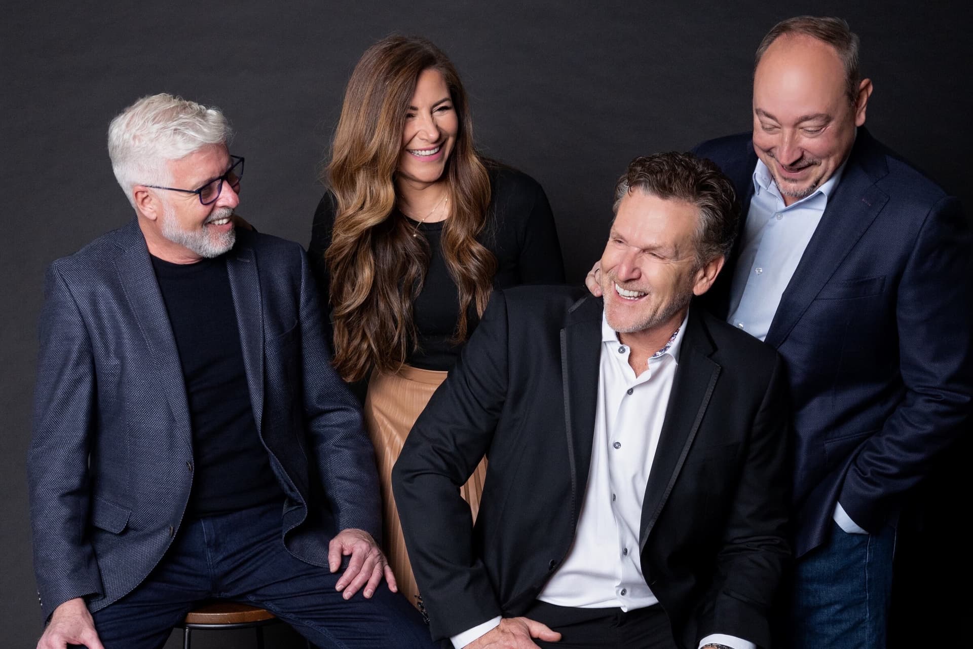 The Dan Cooper Group team laughing together in the studio
