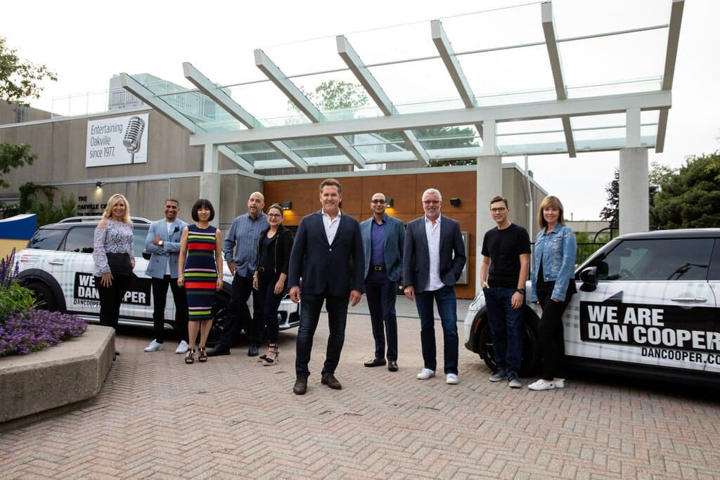 The Dan Cooper Group team with the branded Mini Cooper fleet