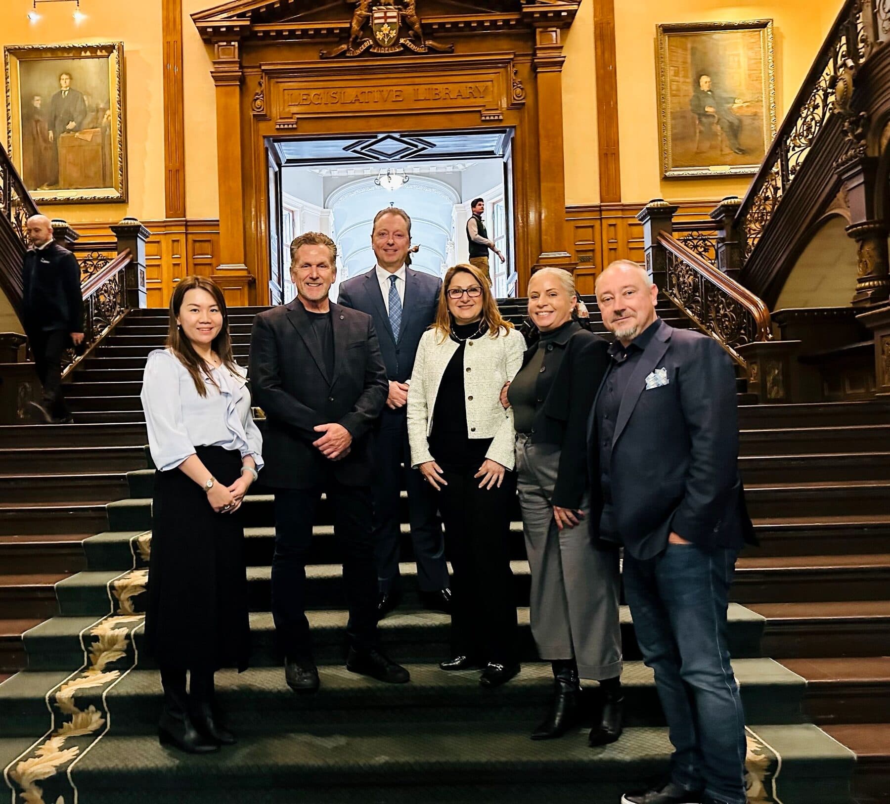 The Dan Cooper Group team on a grand staircase
